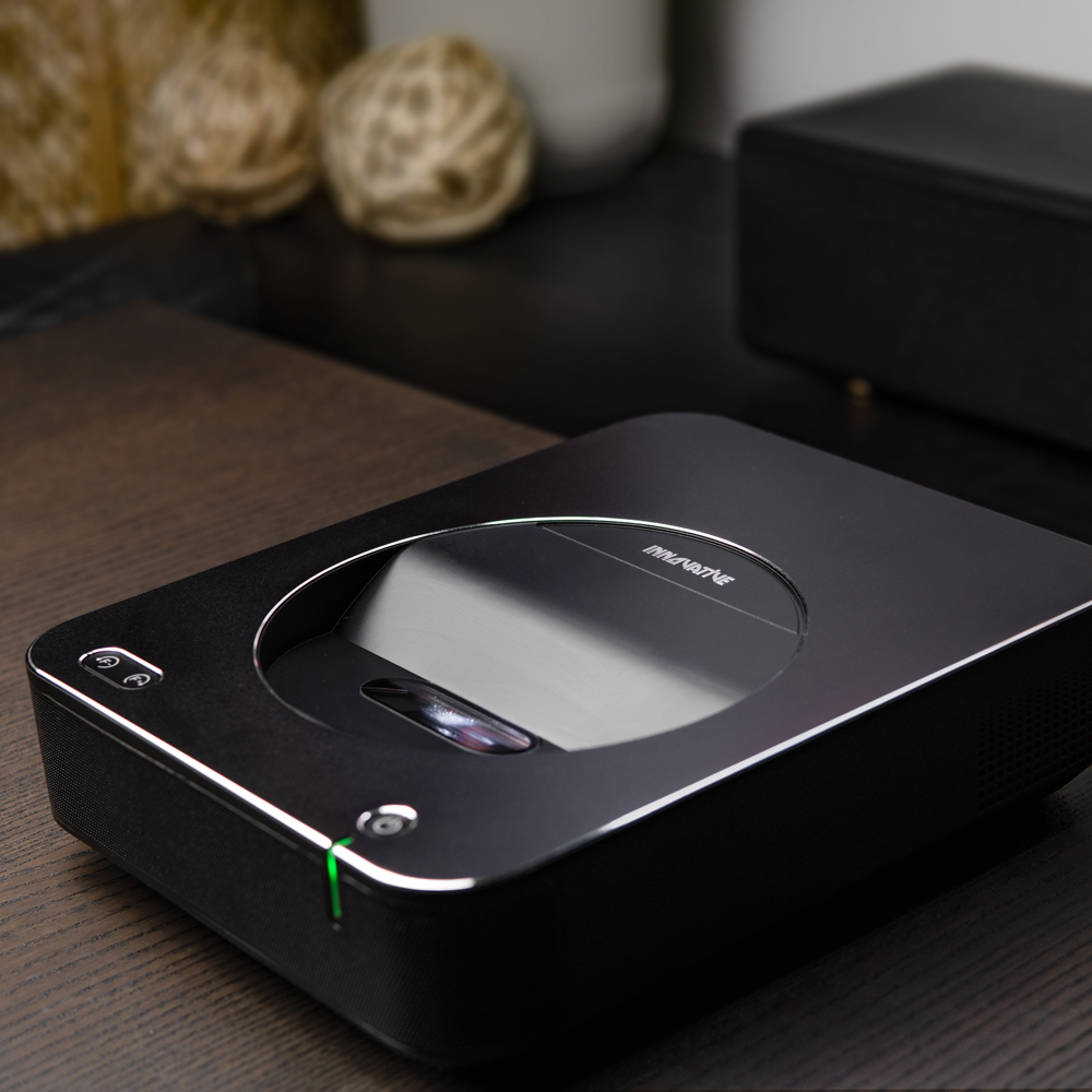 INNOVATIVE DSX Ultra Short Throw Projector holding in the hand